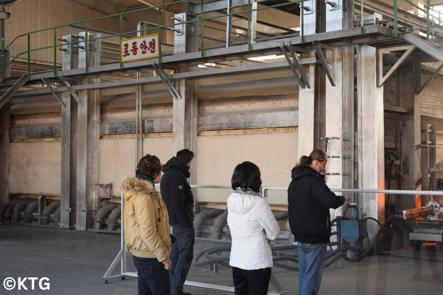 KTG travellers checking the glass produced at the Tae'an Glass Factory in Nampo, North Korea (DPRK)