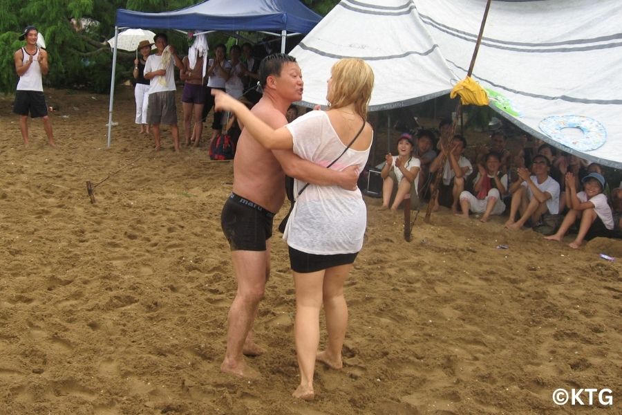 Western tourist with North Korean locals at a North Korean beach, Majon beach in Hamhung city, DPRK. Trip arranged by KTG Tours