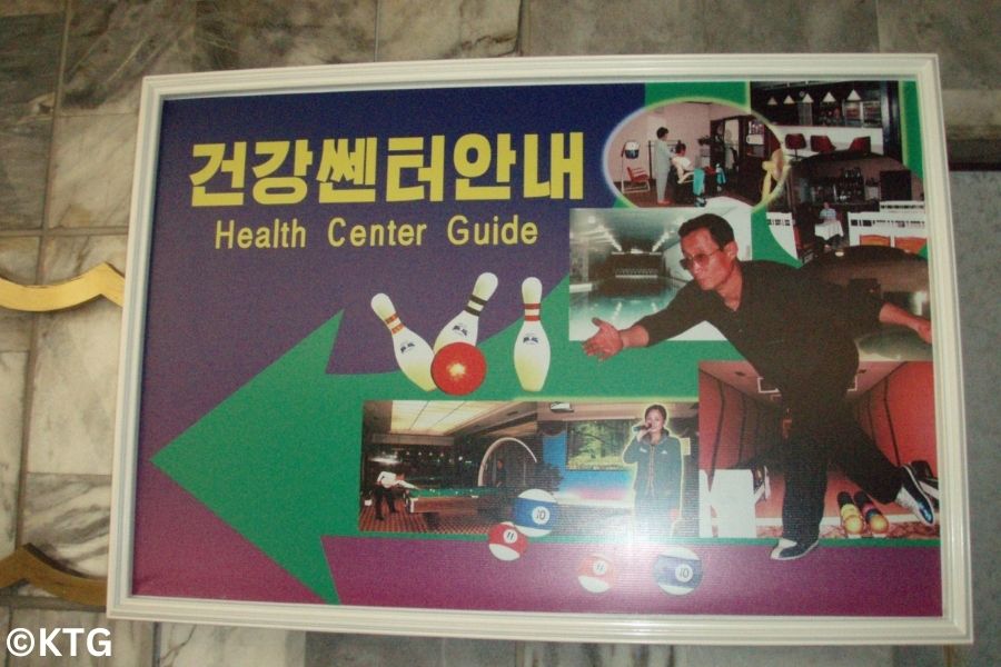 Poster sign at the Yanggakdo Hotel featuring the hotel's Bowling Alley, Pyongyang, North Korea