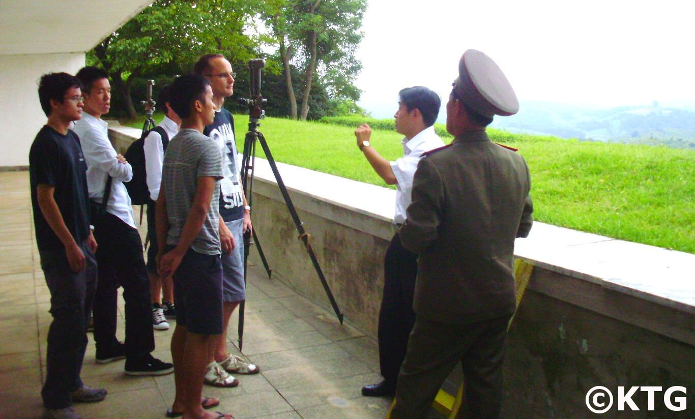North Korea officer explains to KTG travellers where the Concrete Wall across the DMZ in South Korea is. The DPRK Colonel answers any questions we may have