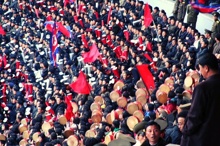 North Korean football fans supporting the DPRK in a match against Japan at Kim Il Sung Stadium in Pyongyang capital of North Korea. Football trip arranged by KTG Tours
