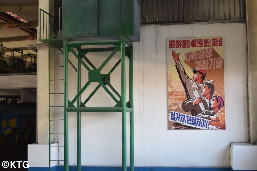 North Korean propaganda poster at the Tae'an Glass Factory in Nampo, North Korea (DPRK)