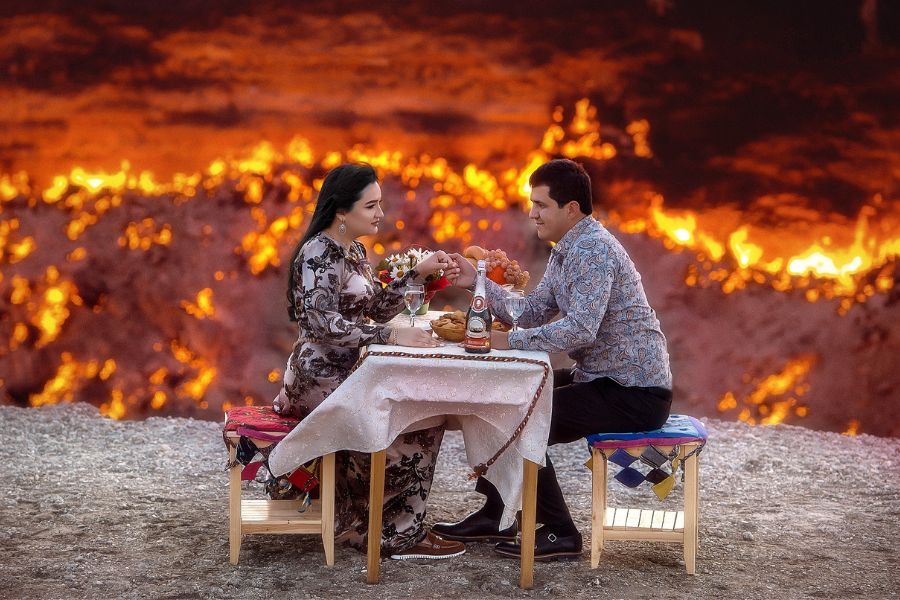 Turkmen couple eating by the Darvaza Crater in Turkmenistan