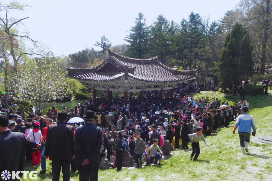 Hundreds of North Koreans dancing and celebrating Labour Day i.e. May Day at Moranbong Park i.e. Moran Hill in the centre of Pyongyang capital of North Korea, the DPRK. Picture taken by KTG Tours experts in DPRK North Korea tours.