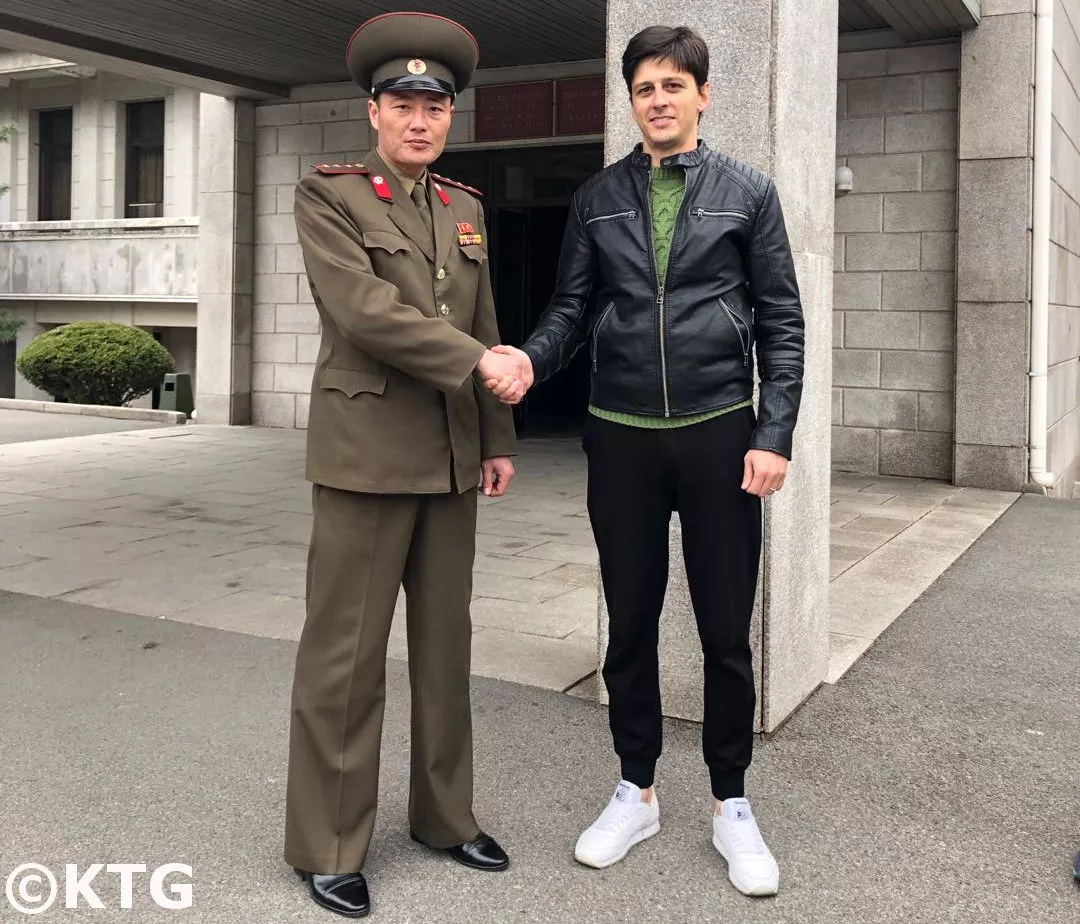 North Korean military officer shakes hand with KTG staff member Rayco Vega at Panmunjom in the DMZ in North Korea.